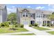 Charming townhome featuring a well-manicured lawn, attached garage, and inviting exterior at 113 Cozy Nest Way, Summerville, SC 29483