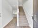Welcoming foyer with hardwood floors, a staircase, and views into the kitchen area at 113 Cozy Nest Way, Summerville, SC 29483