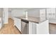 Kitchen island features a stainless steel dishwasher, double sink, and white cabinets at 113 Cozy Nest Way, Summerville, SC 29483