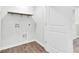 Bright laundry room features laminate flooring, a white door, and utility connections at 113 Cozy Nest Way, Summerville, SC 29483