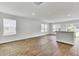 Sunlit living room featuring wood flooring, multiple windows, and views of the outdoors at 113 Cozy Nest Way, Summerville, SC 29483