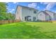 Spacious backyard with a well-maintained lawn, privacy fence, and outdoor seating area at 115 Cooper Dr, Summerville, SC 29483