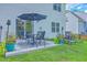 Enjoy outdoor living on this backyard patio with table, chairs, umbrella, and colorful flower pots at 115 Cooper Dr, Summerville, SC 29483