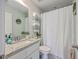 This bathroom features a vanity with granite countertop and ample storage, plus a shower with a patterned curtain at 115 Cooper Dr, Summerville, SC 29483