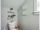 Powder room with modern toilet, decorative wall art, and white wainscoting at 115 Cooper Dr, Summerville, SC 29483
