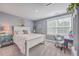 Charming bedroom with white bed, neutral decor, natural light, and green accents for a fresh, inviting feel at 115 Cooper Dr, Summerville, SC 29483
