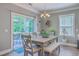 Elegant dining room with a wooden table, bench, and chairs, and a view of the outdoor deck at 115 Cooper Dr, Summerville, SC 29483