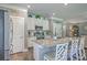 Open kitchen featuring stainless appliances, white cabinetry, granite counters, and a large island at 115 Cooper Dr, Summerville, SC 29483