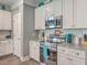 Kitchen with stainless steel appliances, white cabinetry, granite counters and subway tile backsplash at 115 Cooper Dr, Summerville, SC 29483