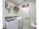 Functional laundry room with modern washer, dryer, wire shelving, and convenient folding table at 115 Cooper Dr, Summerville, SC 29483