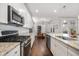 Modern kitchen with stainless appliances, granite counters, and dark hardwood floors at 121 Warbler Way, Summerville, SC 29483