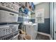 Functional laundry room with shelving, storage baskets, and a modern washer and dryer set at 121 Warbler Way, Summerville, SC 29483