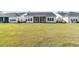 Lush backyard with a screened porch overlooking a well-manicured lawn at 1213 Locals St, Summerville, SC 29485
