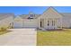 Charming single-Gathering home features a three-car garage and a well-manicured front lawn at 1213 Locals St, Summerville, SC 29485