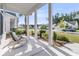 Relaxing front porch features comfortable chairs and a view of the well-kept neighborhood at 1213 Locals St, Summerville, SC 29485