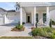 Charming front porch with seating and manicured landscaping at 1213 Locals St, Summerville, SC 29485
