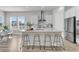 Bright, modern kitchen with a large island, stainless steel appliances, and ample natural light from large windows at 1213 Locals St, Summerville, SC 29485