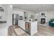 Spacious kitchen with island, stainless steel appliances, and open layout flowing into the living area with a fireplace at 1213 Locals St, Summerville, SC 29485