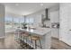 Well-lit modern kitchen with a central island and barstool seating, showcasing a functional and stylish design at 1213 Locals St, Summerville, SC 29485