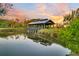Wooden gazebo over pond at sunset creates a tranquil park-like atmosphere at 1213 Locals St, Summerville, SC 29485
