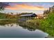 Sunset view of wooden gazebo over pond with a tranquil park-like atmosphere at 1213 Locals St, Summerville, SC 29485