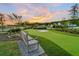 A tranquil bench offers a spot to relax and enjoy a game on the putting green at 1213 Locals St, Summerville, SC 29485