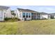 A view of the home exterior showing the yard, air conditioning unit, and screened porch at 1213 Locals St, Summerville, SC 29485