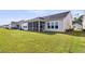 This home boasts a large yard, screened porch, and elegant white siding at 1213 Locals St, Summerville, SC 29485