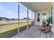 Serene screened porch with cozy seating, overlooking a tranquil lake and lush greenery at 1213 Locals St, Summerville, SC 29485
