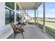 Inviting screened porch with comfortable seating and scenic views of the lake at 1213 Locals St, Summerville, SC 29485