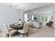 Dining room featuring a round table set, chandelier lighting, and access to the backyard at 122 Stewart Pl, Summerville, SC 29485