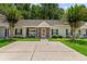 Charming single-story home with a brick and siding facade, well-manicured lawn, and flowering trees at 122 Stewart Pl, Summerville, SC 29485