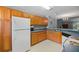 Functional kitchen featuring wood cabinets, laminate countertops, and white appliances at 122 Stewart Pl, Summerville, SC 29485