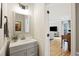 Stylish half-bathroom with modern vanity, decorative mirror, and hardwood floors at 1228 Walleye Cor, Charleston, SC 29414