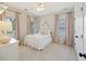 Charming bedroom featuring a white metal bed frame, soft pink accents, and lots of natural light from the windows at 1228 Walleye Cor, Charleston, SC 29414