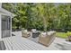 Enjoy the outdoor space of this home on the large deck with outdoor seating and a stylish outdoor rug at 1228 Walleye Cor, Charleston, SC 29414