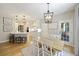 Open-concept dining area with hardwood floors, view into the kitchen, and modern light fixture at 1228 Walleye Cor, Charleston, SC 29414