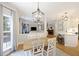 Light filled dining area with hardwood floors, view of living room, and modern chandelier at 1228 Walleye Cor, Charleston, SC 29414