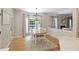 Bright dining area featuring hardwood floors, large windows, and modern light fixture at 1228 Walleye Cor, Charleston, SC 29414