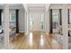 Bright foyer with hardwood floors, white pillars, and natural light, creating an inviting and open entrance at 1228 Walleye Cor, Charleston, SC 29414