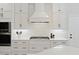 Modern kitchen with white cabinets, sleek countertops, stainless steel appliances, and contemporary design elements at 1228 Walleye Cor, Charleston, SC 29414