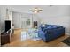 Spacious living room featuring hardwood floors, natural light, a ceiling fan, and a plush blue sofa at 1228 Walleye Cor, Charleston, SC 29414
