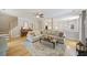 Comfortable living room with hardwood floors, fireplace, and view into kitchen and dining areas at 1228 Walleye Cor, Charleston, SC 29414