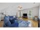 Cozy living room with a plush blue sofa, hardwood floors, a ceiling fan, and artwork on the wall at 1228 Walleye Cor, Charleston, SC 29414