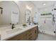 Bright main bathroom featuring dual sinks, modern fixtures, and a glass shower at 1228 Walleye Cor, Charleston, SC 29414