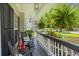 Inviting covered front porch with black rocking chairs, lanterns, and lush greenery, perfect for relaxing outdoors at 1228 Walleye Cor, Charleston, SC 29414