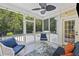 Outdoor screened-in porch featuring comfortable seating, decorative lighting, ceiling fan, and a view of the backyard at 1228 Walleye Cor, Charleston, SC 29414