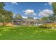 Spacious backyard with a well-maintained lawn, screened-in porch, and charming landscaping at 125 Sumners Aly, Summerville, SC 29485