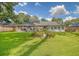 Wide shot of the beautiful backyard featuring green grass and flower beds, providing privacy and beauty at 125 Sumners Aly, Summerville, SC 29485