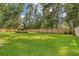 Expansive backyard featuring lush green grass, privacy fence and landscaped garden beds at 125 Sumners Aly, Summerville, SC 29485